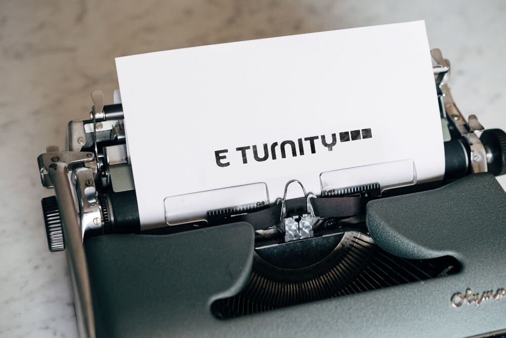 typewriter-with-paper-in-it-eturnity-logo-on-paper